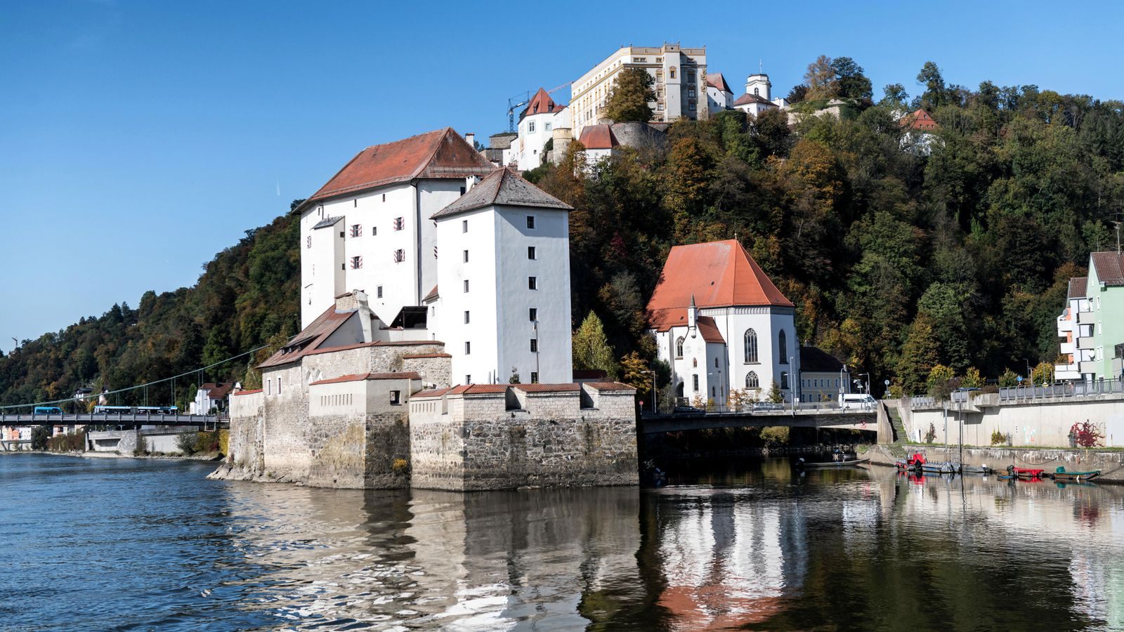 Passau on the Danube reflected in calm water, where many family river cruise Europe itineraries begin