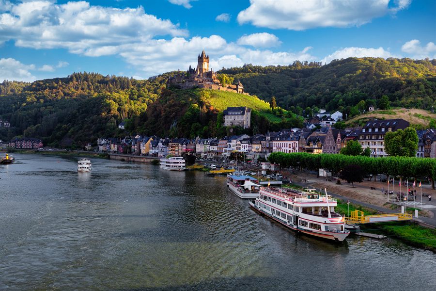 Cochem Castle above a moored river cruise ship