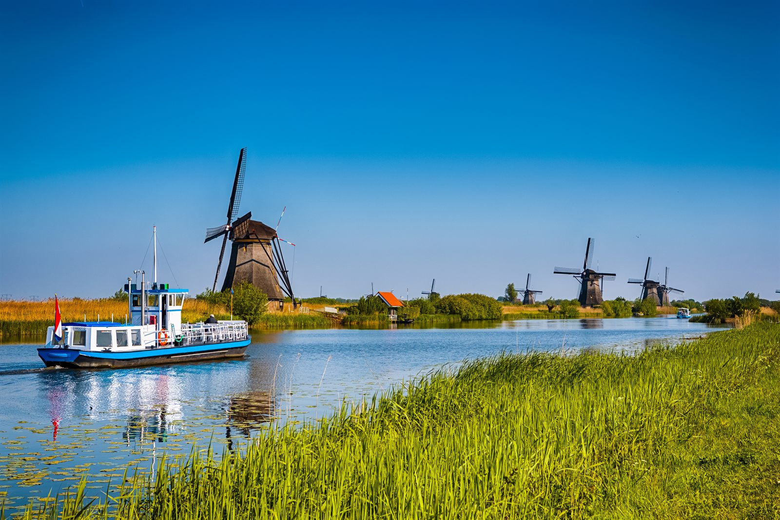Windmills of Kinderdijk beside a canal, a favorite stop on any family friendly river cruise Europe offers