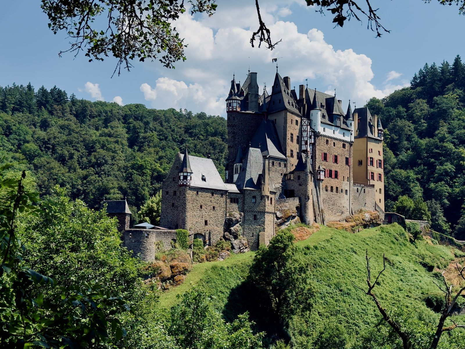 Eltz Castle rising from the forest near the Moselle, a castle visit offered on family river cruises Europe 2027 itineraries
